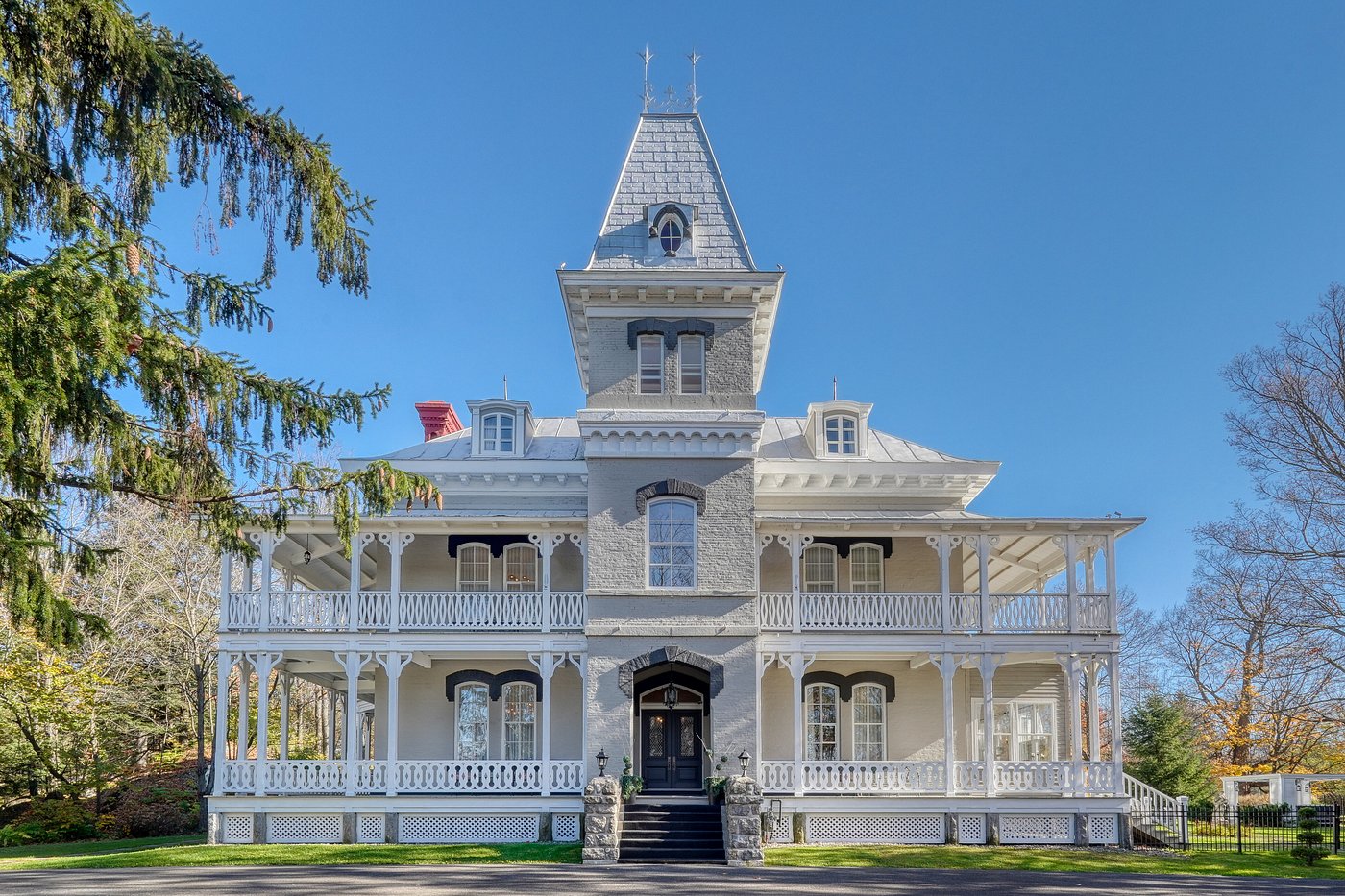 Grand Victorian manor facade with wraparound porch